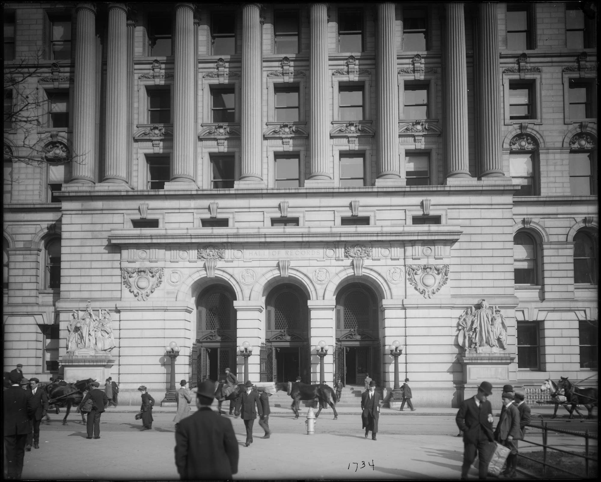 Black and white photograph of Surrogate Court building showing horses and passerby