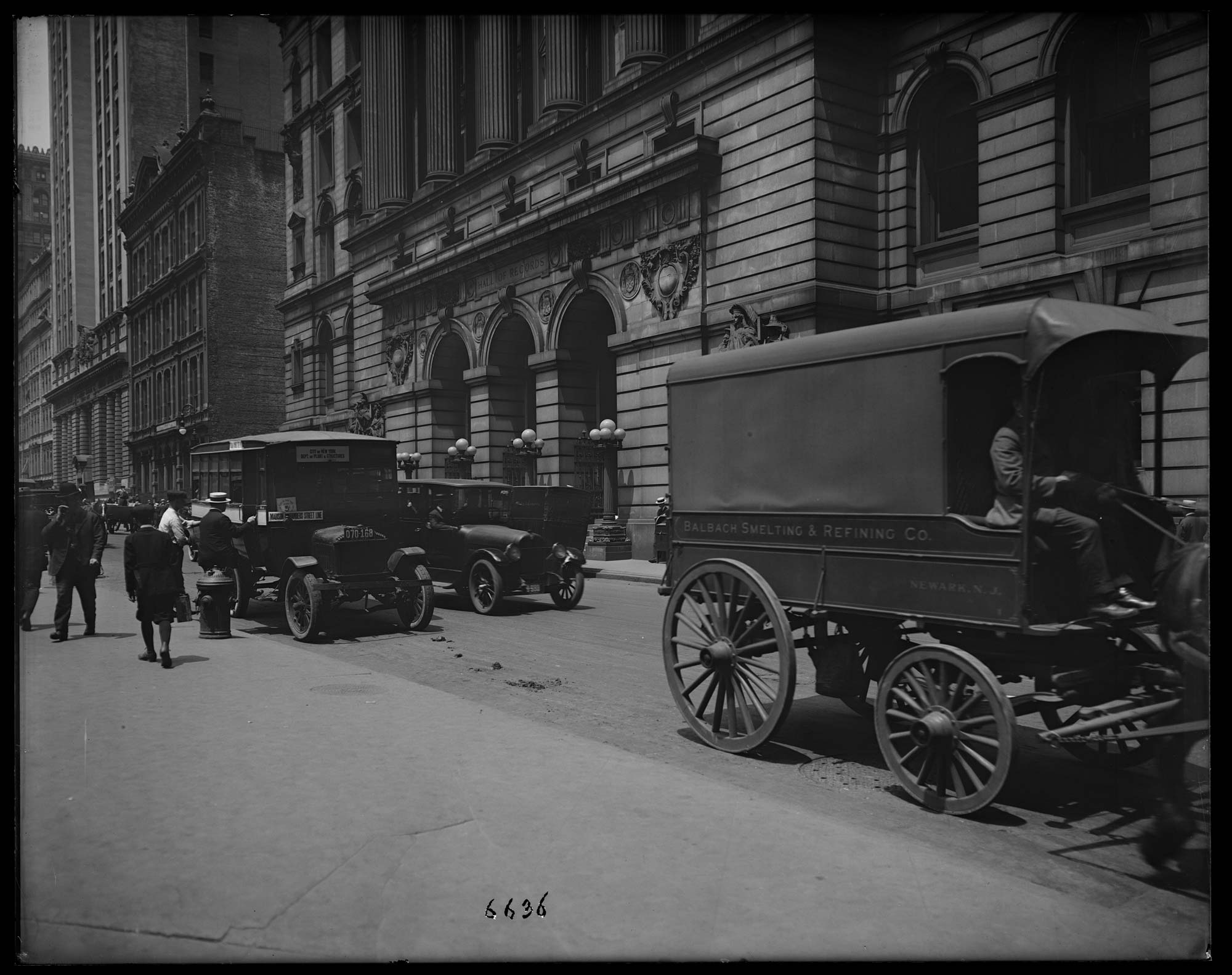 Black and white photograph of Surrogate Court building showing local shuttle wagon and passerby.