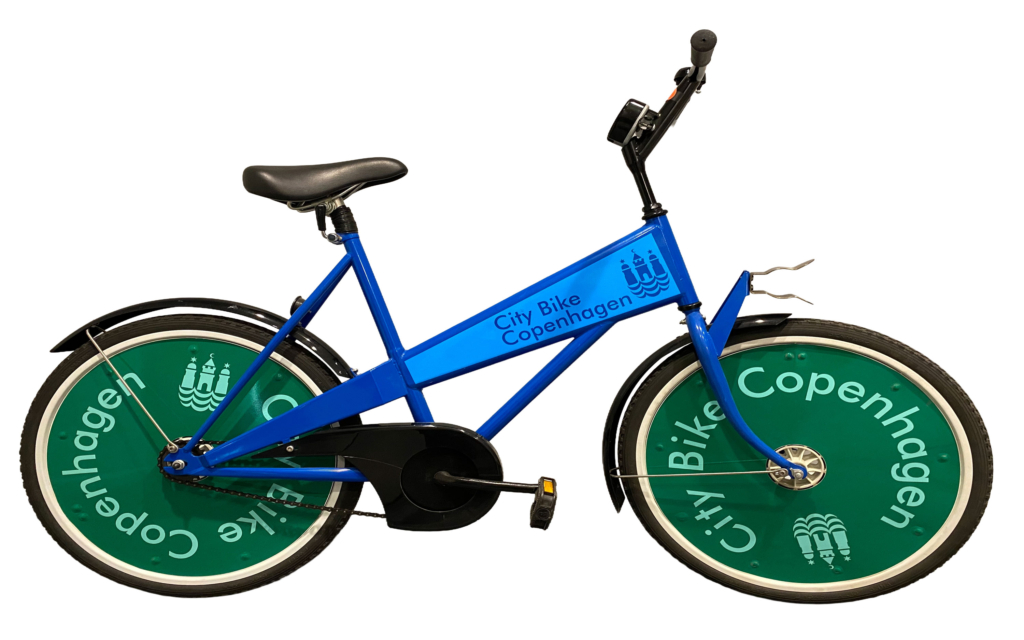 Rendering of bicycle from Copenhagen's bike sharing program. The bicycle has green wheel covers displaying city crown logo and the "City Bike Copenhagen" branding. The bike features a black seat, a mount for front basket and a blue body that also includes company name and city logo.