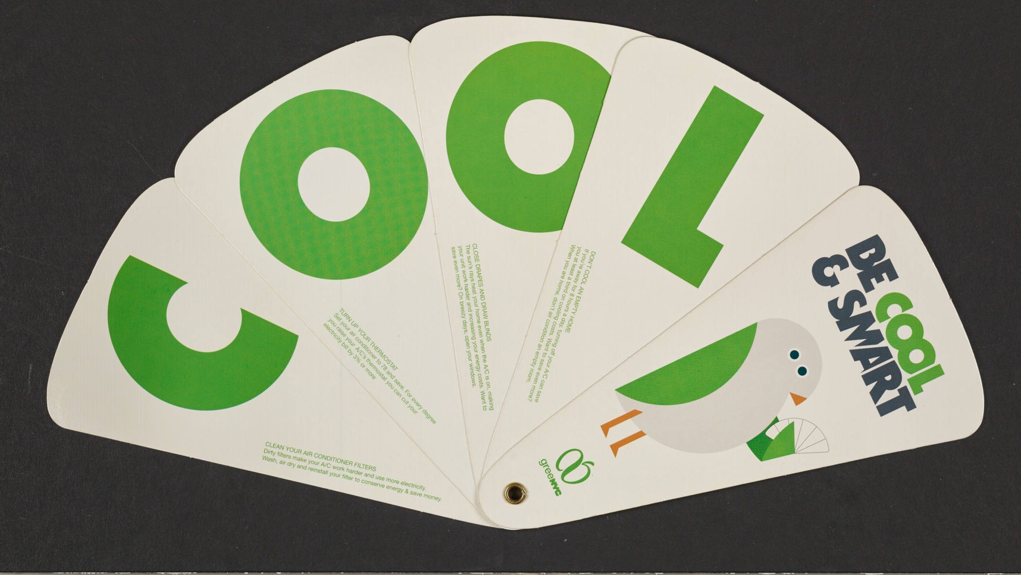 Open cardboard fan with the word COOL on one side and bird eyes and a beak on the other. There is a slogan "Be Cool & Smart."